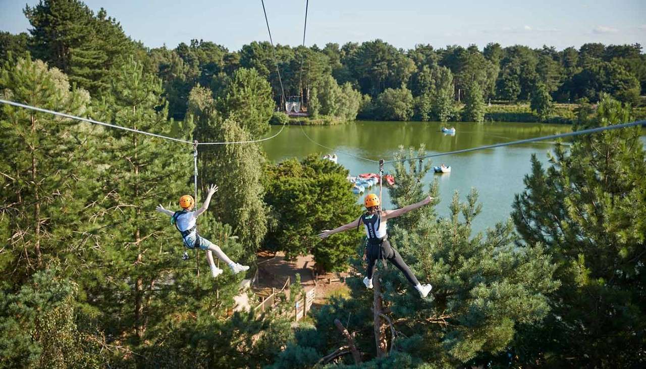 People on Zip wire going over the lake.
