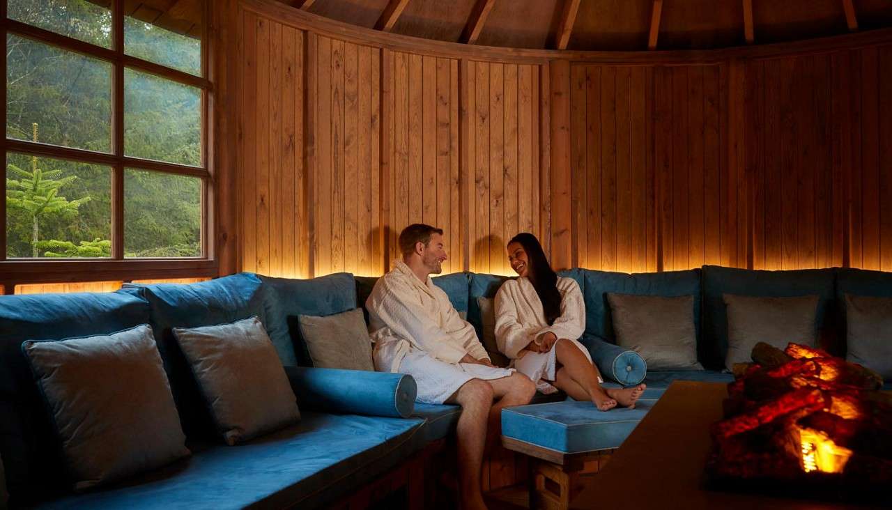 Couple sitting in the Scandinavian Snug in the Aqua Sana Forest Spa