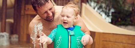 boy and man playing in the Subtropical swimming paradise