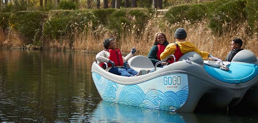 A family in an electric boat on the lake 