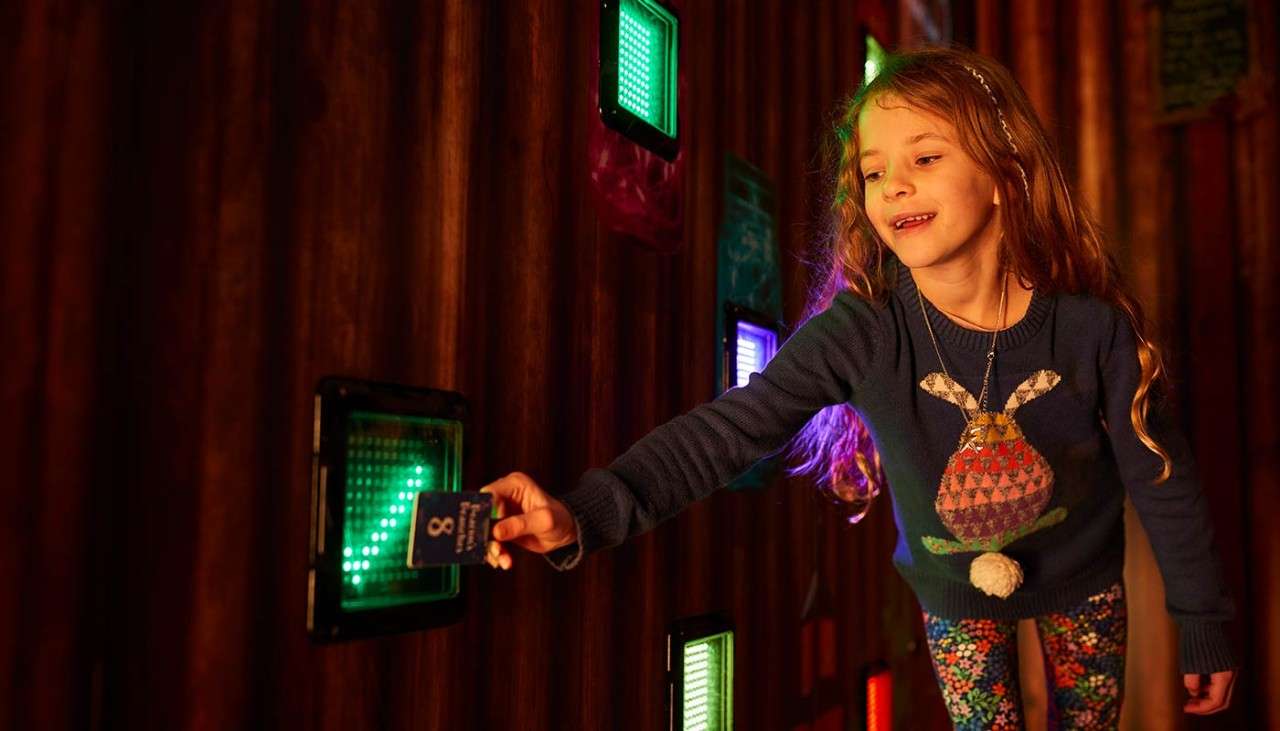 A girl interacting with the interactive wall.