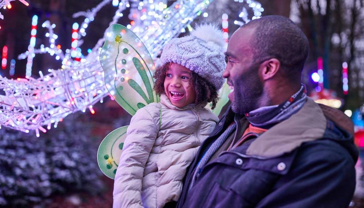 A young girl and her father looking at the magical Enchanted Light Garden