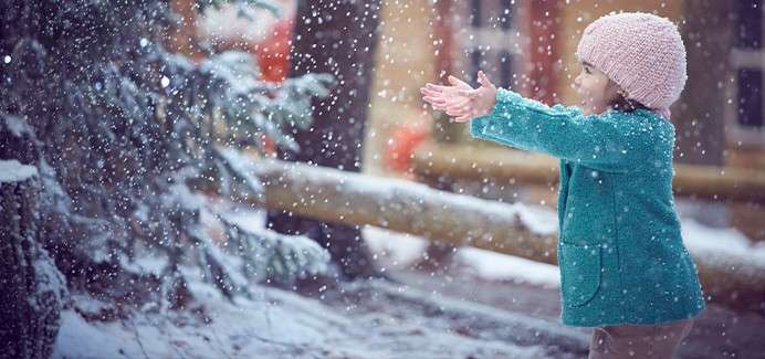 A girl holding her hands in the snow