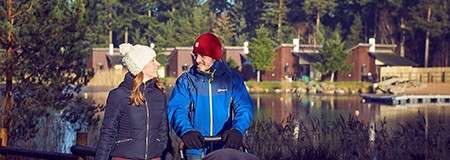 A couple walking by the lake.