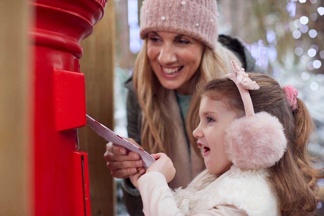 Girl posting letter to santa