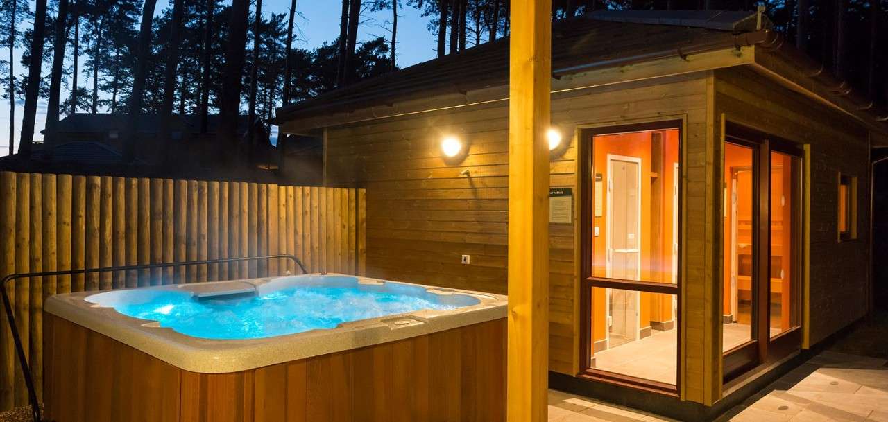Patio area with hot tub and sauna