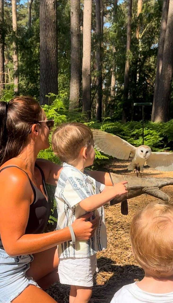A young boy and his mother with an owl