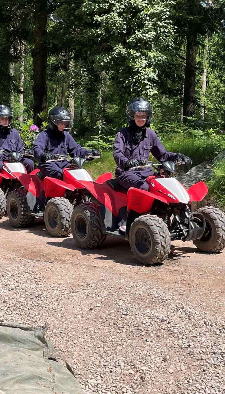 Family on quad bikes in the forest