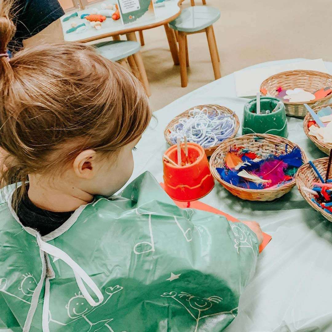 Young girl getting messy in the Activity Den