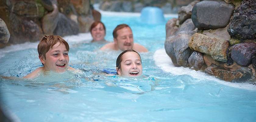 Family going down the Wild Water Rapids in the Subtropical Swimming Paradise