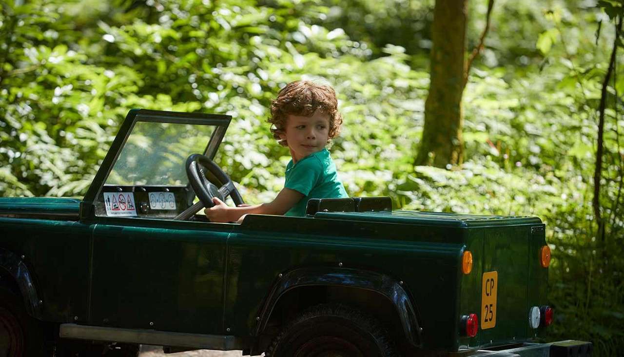 A boy in an off-road explorers car