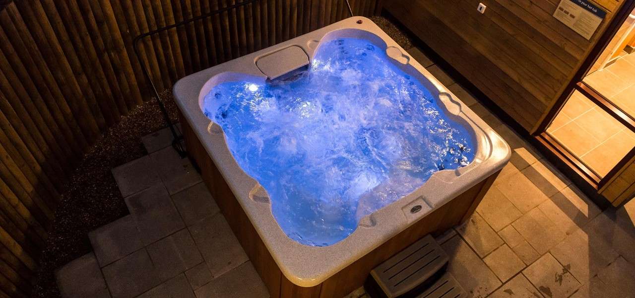 Private hot tub lit up at night