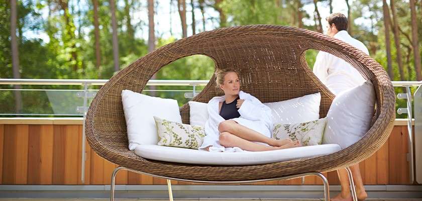 A couple on the balcony of a spa suite