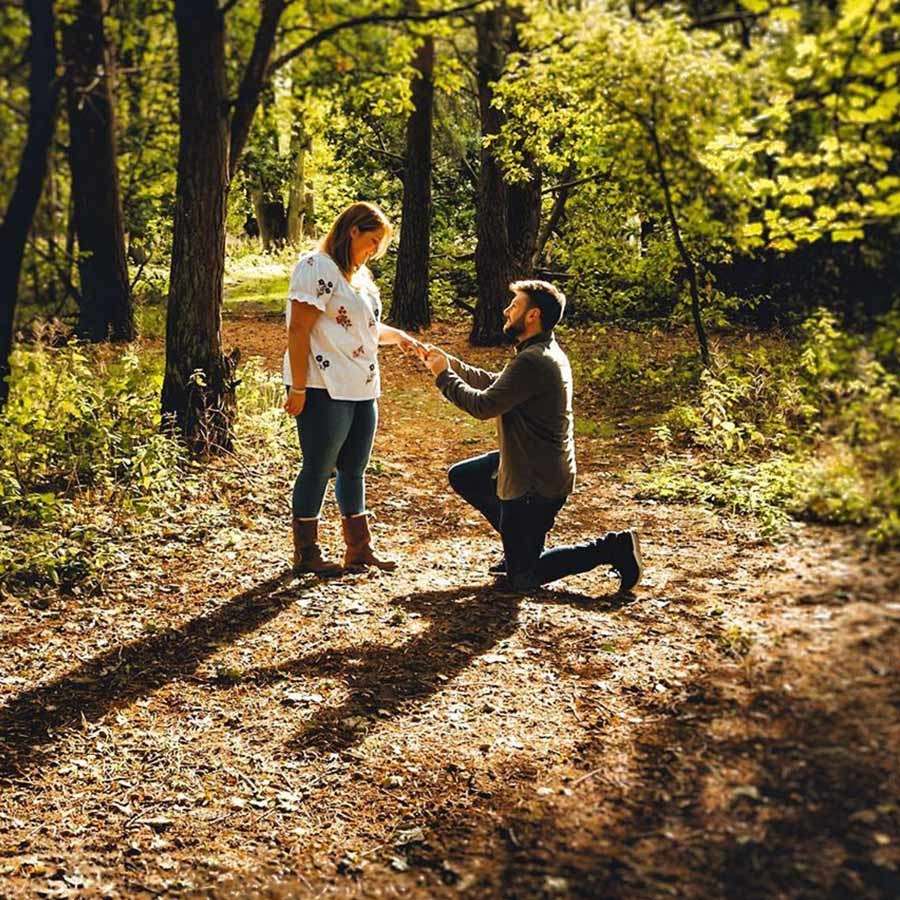 Man proposing to his partner in the forest