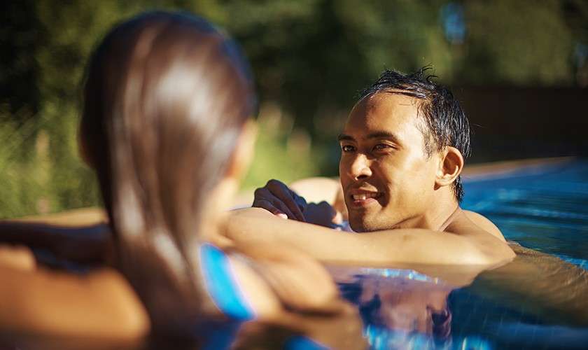 Couple relaxing in an outdoor pool at Aqua Sana Spa