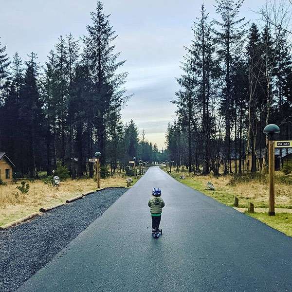 A young boy on a scooter 