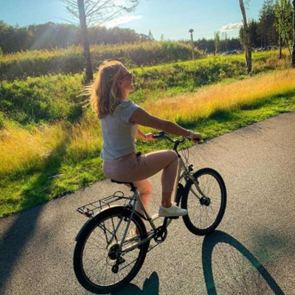 A woman on her bike cycling in the village