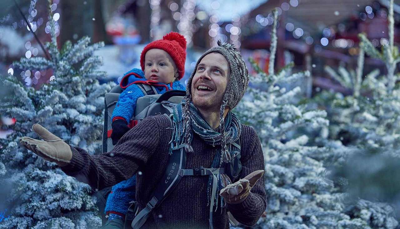 Man and child enjoy the snow