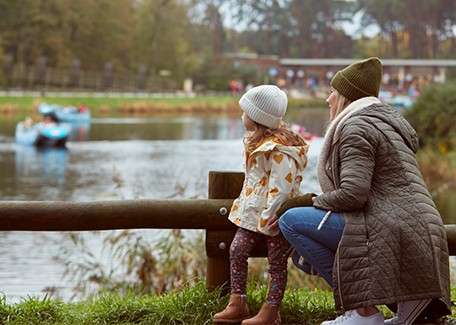 A mother and daughter looking over at the lake.