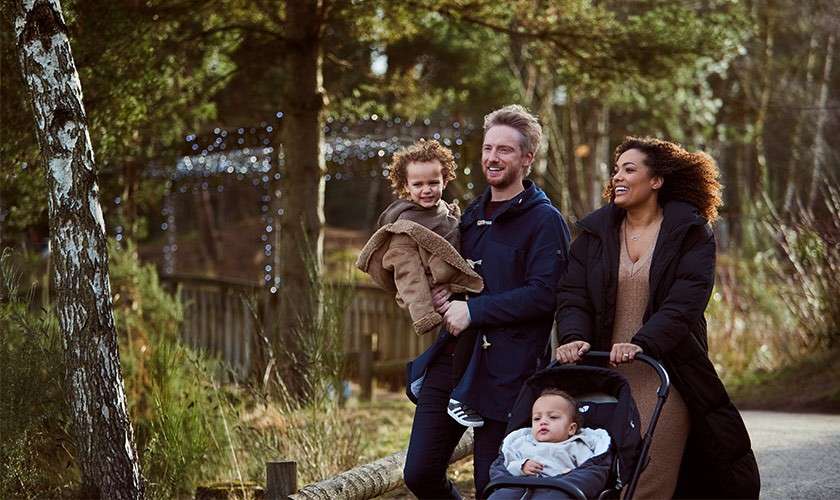 A family walking together through the forest.