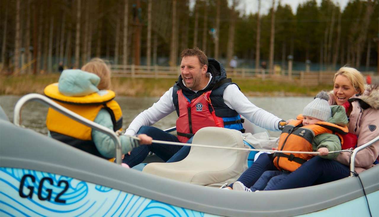 Family sitting in an Electric Boat on the lake.