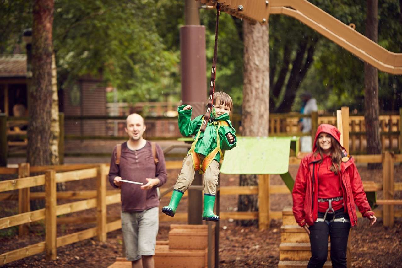 Young boy climbing over the Mini Trek course.