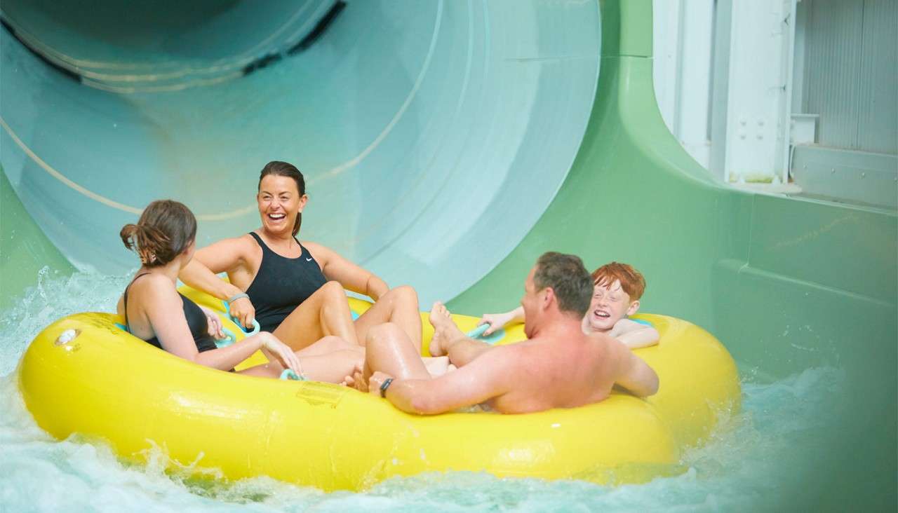 Group sitting in an inflatable going down the Tropical Cyclone