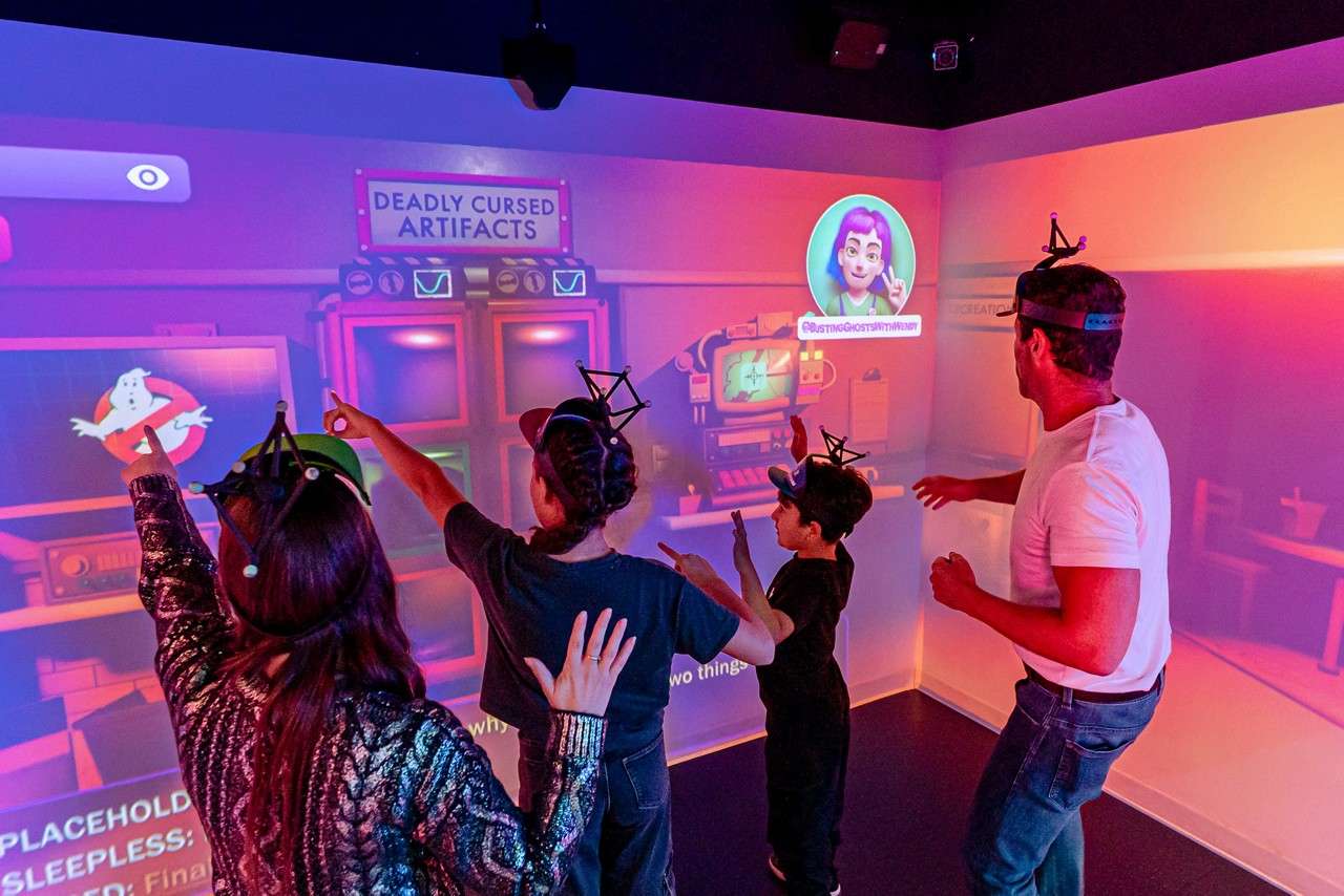 Group in a room with projections