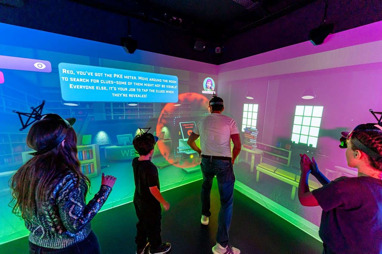 Group in a room with projections