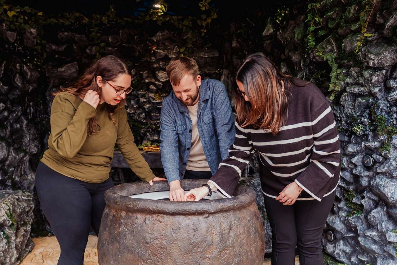 A group looking into a cauldron.