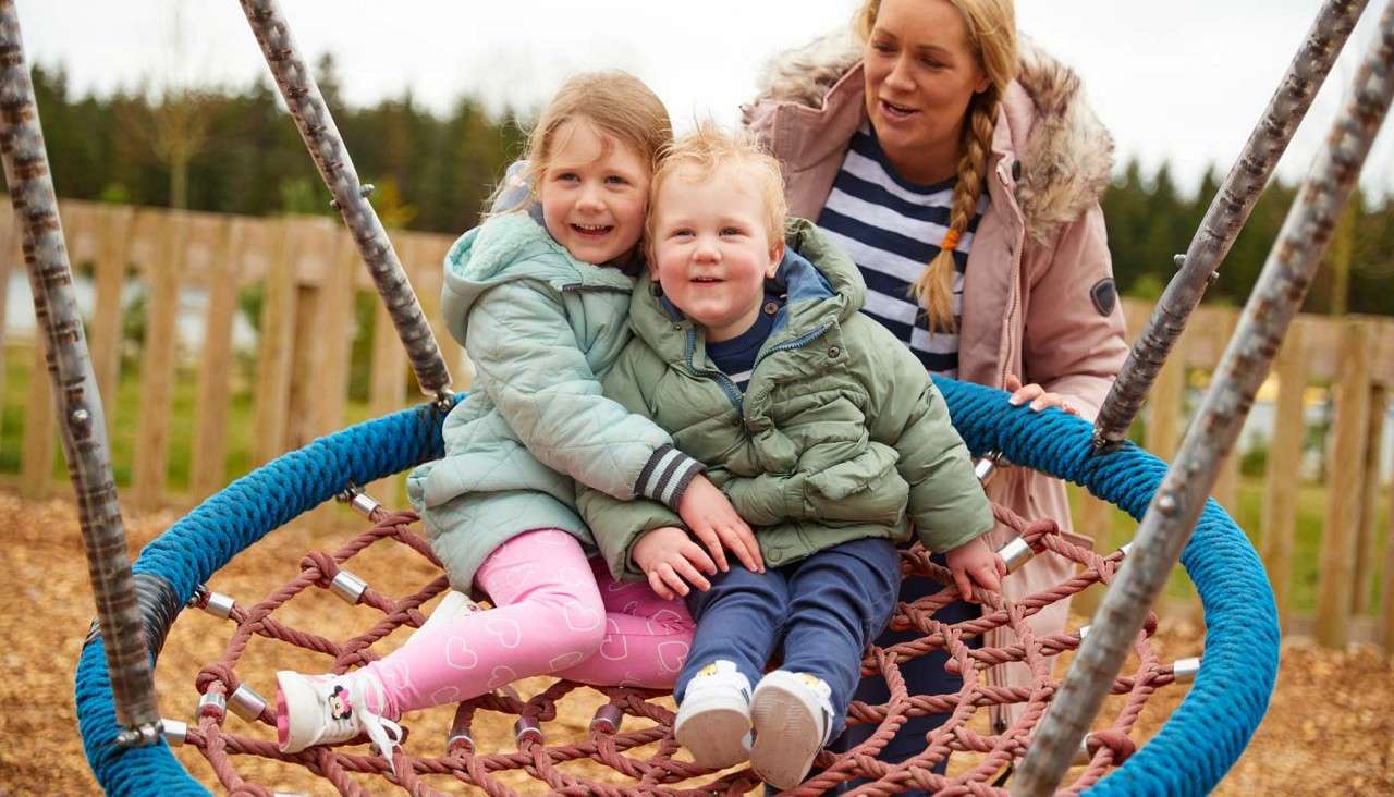 Two children sitting in a swing