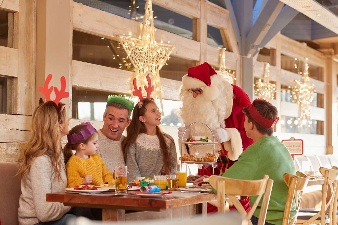 Family having a brunch whilst Santa passes by.