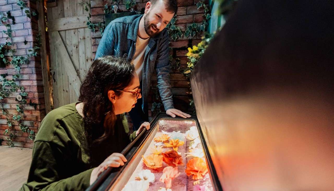 Two people looking for clues in an escape room.