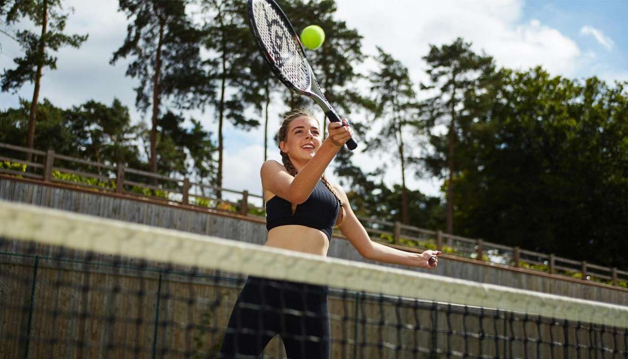 Teenage girl playing Tennis