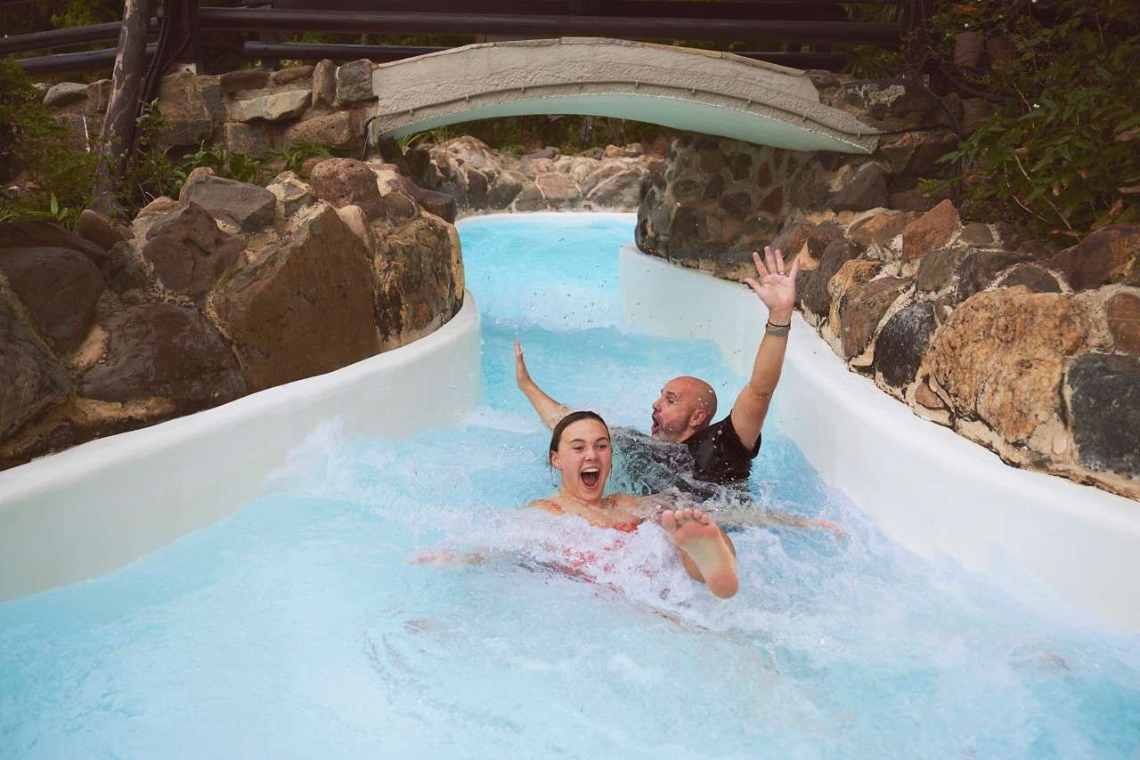 Couple sliding down the Wild Water Rapids.