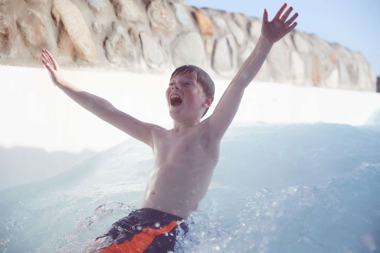 Couple sliding down the Wild Water Rapids.