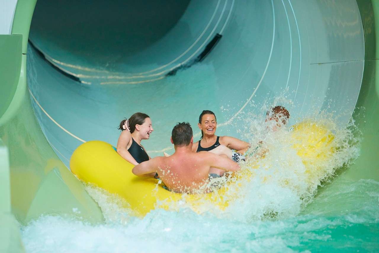 Family riding in an inflatable raft.