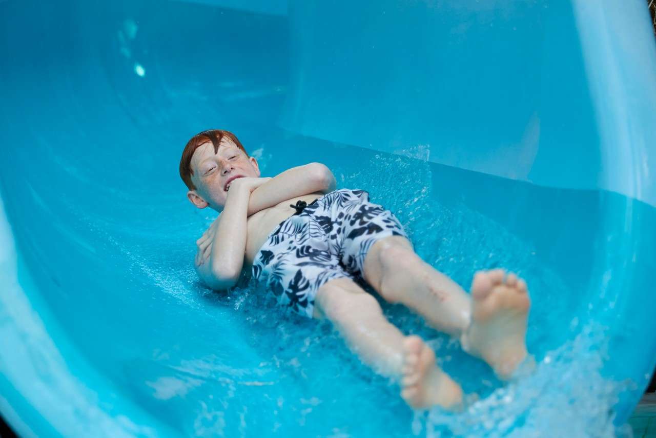 Young boy going down the Twister ride.