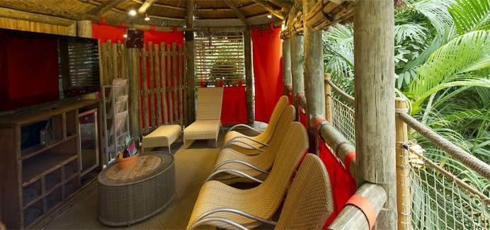 Inside a Family Cabana with a TV, lounge seating and other luxuries.