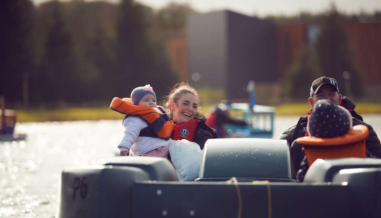 A family on a pedalo on the lake 