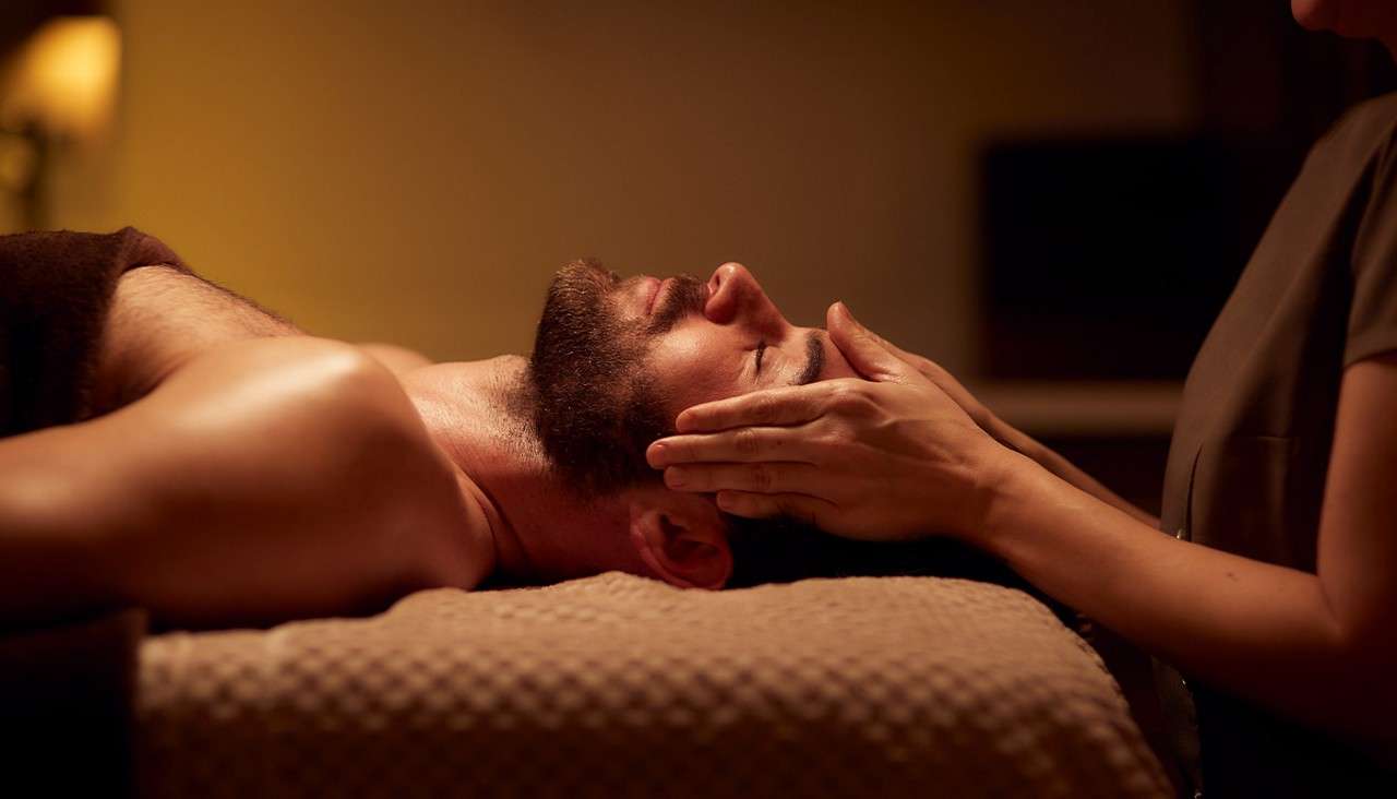A man getting a face massage at Aqua Sana Spa