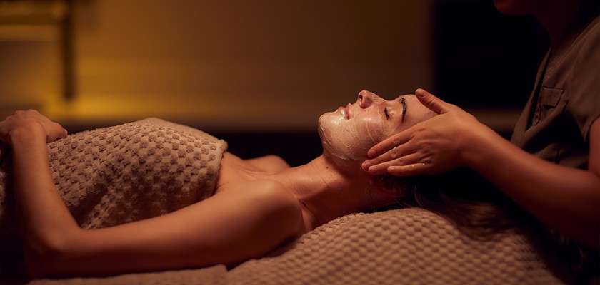 A woman getting a facial at a spa
