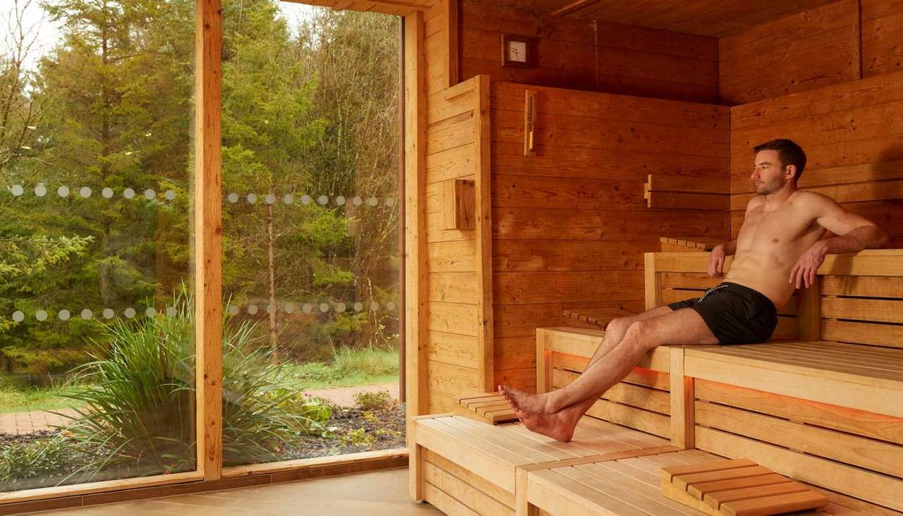 Man lounging in a Nordic Sauna 