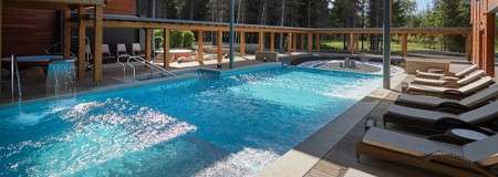 Outdoor pool surrounded by sun loungers 