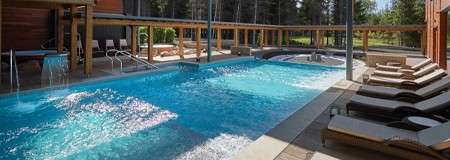 Outdoor pool surrounded by sun loungers 