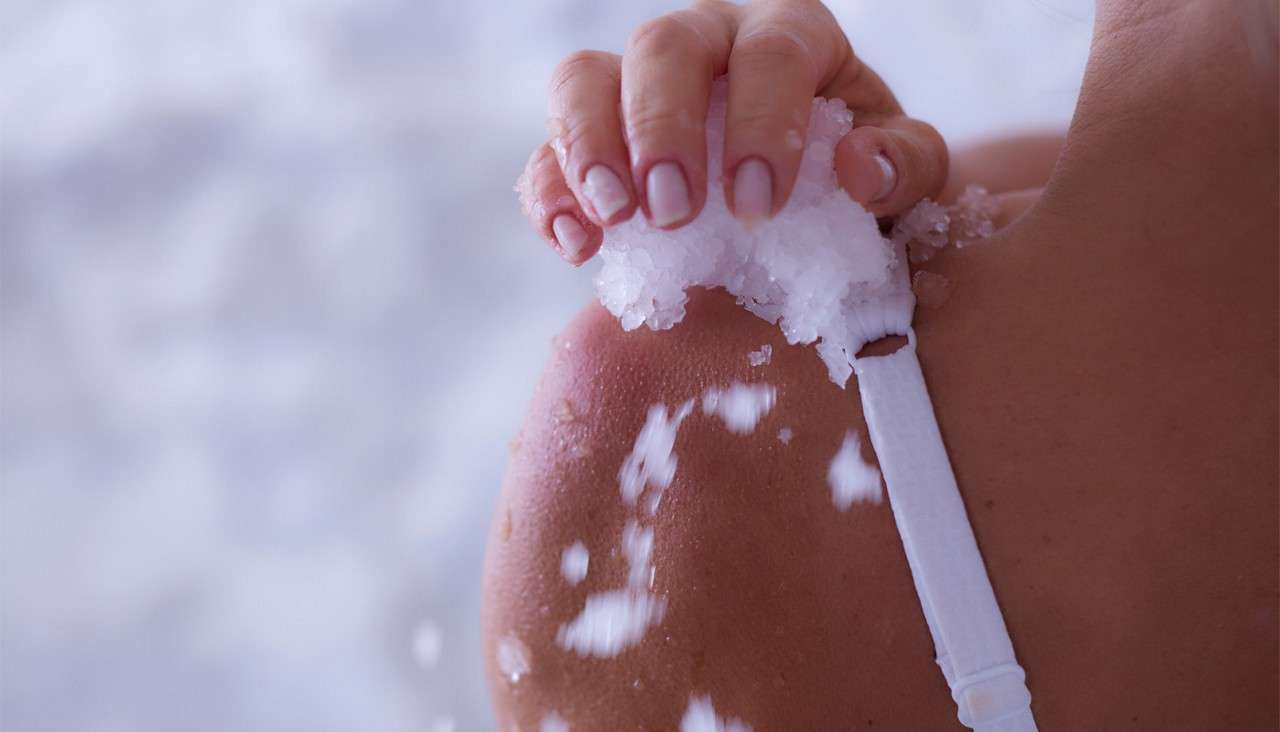 Woman applying ice to her skin.