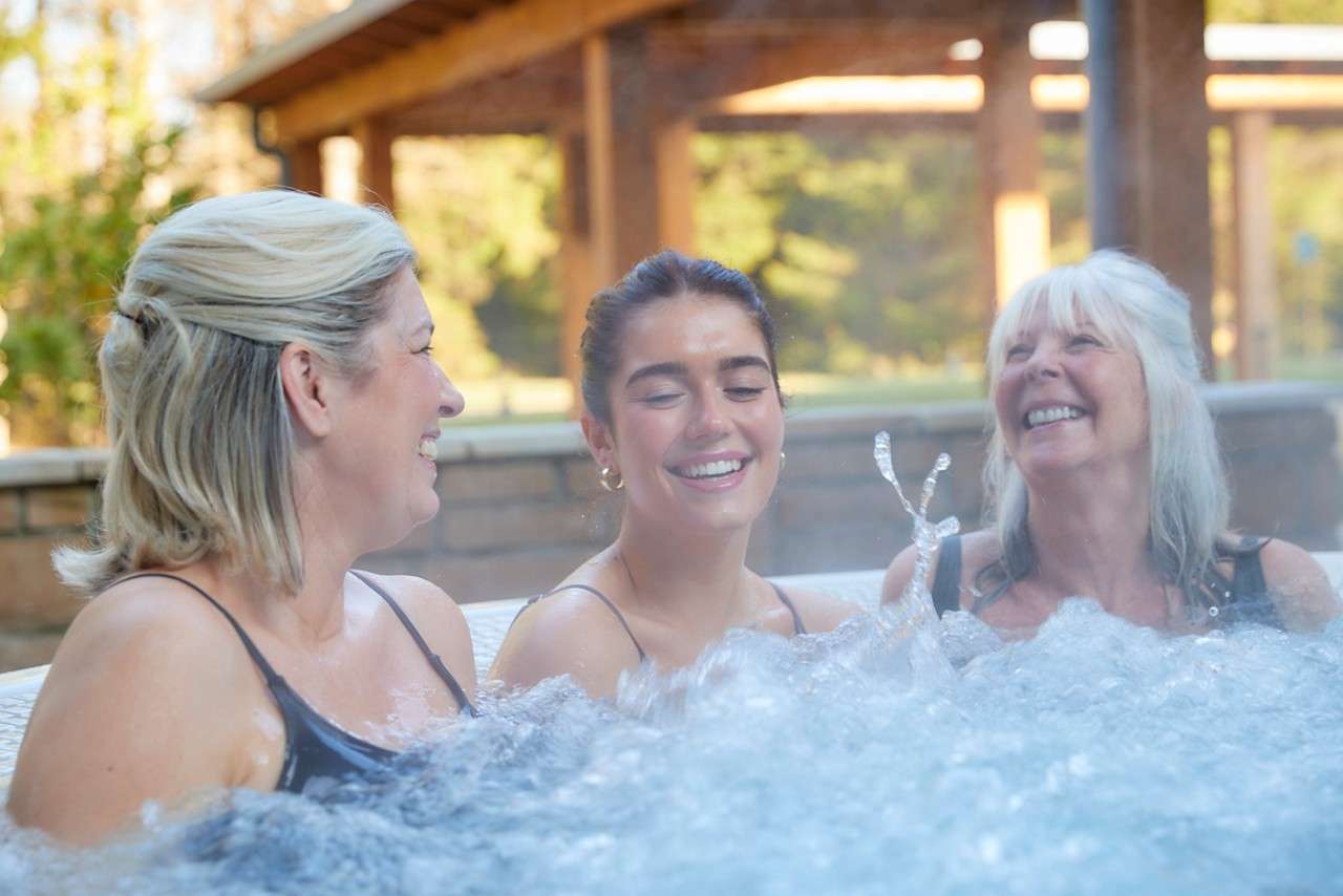 Women soaking in a bubbling hot tub.