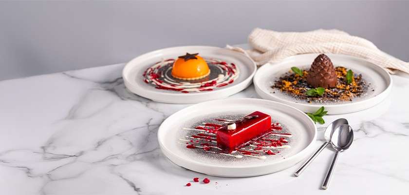 A selection of desserts including chocolate mousse and fruit tarts.