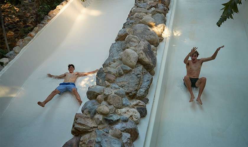 A family on the tropical cyclone slide in the Subtropical Swimming Paradise.