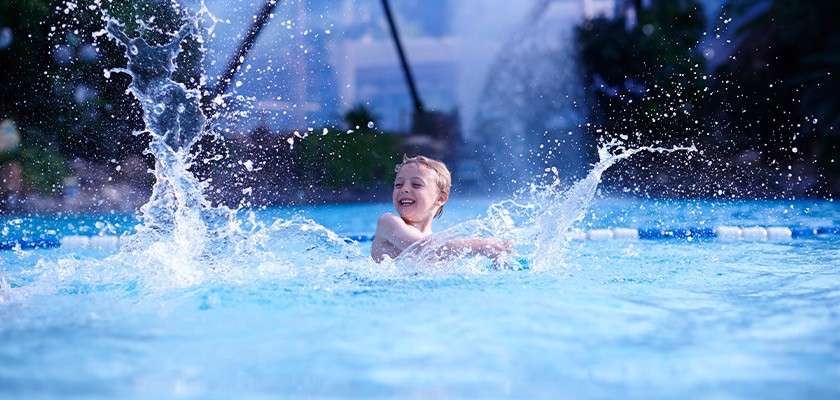 A boy splashing in the Subtropical Swimming Paradise